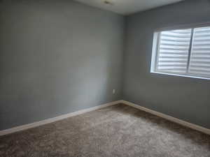 Spare room with light colored carpet and baseboards