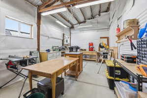 Miscellaneous room with finished concrete floors and a workshop area