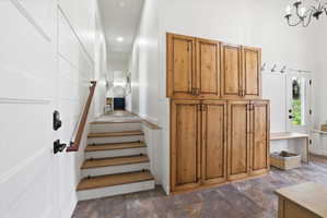 Stairs with stone finish floors and baseboards