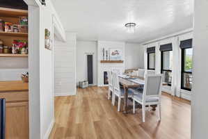 Dining area with light wood finished floors and a textured ceiling