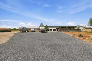View of front of home with driveway and a garage