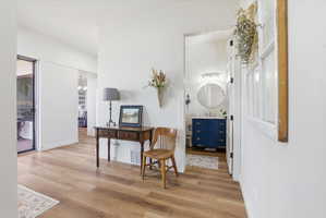 Hall featuring light wood finished floors