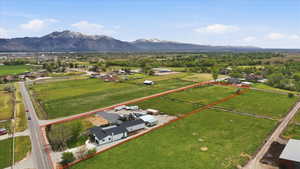 Aerial view of sparsely populated area with property parcel outlined and a mountain backdrop