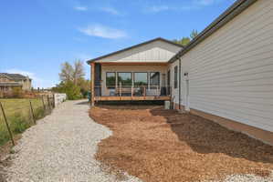 Back of property with a deck and board and batten siding