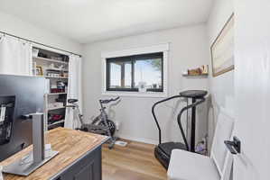 Office space with light wood-type flooring and baseboards