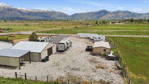 Overview of rural landscape featuring a mountainous background and agricultural land