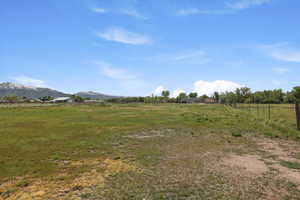 View of yard with a rural view and a mountain view