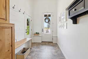 Mudroom featuring stone finish flooring and baseboards
