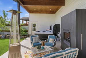 View of patio with a hot tub and outdoor furniture