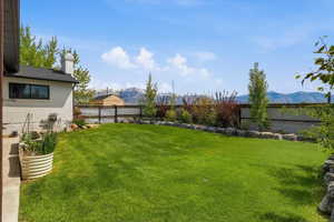 Fenced backyard with a mountain view