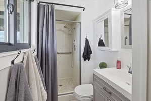 Bathroom featuring vanity and a stall shower
