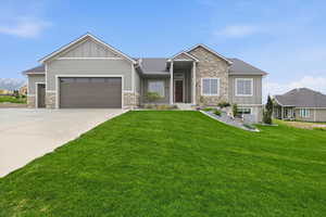 Craftsman-style house featuring stone siding and board and batten siding