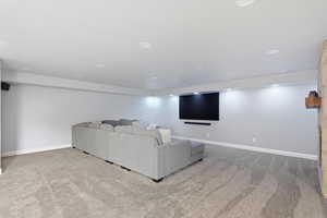 Living room with light carpet and recessed lighting