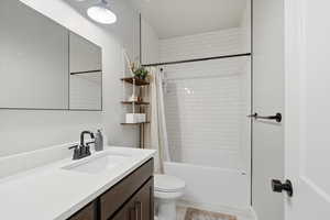 Bathroom with vanity and shower / tub combo with curtain