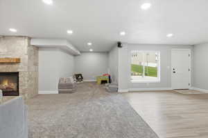 Game room featuring a fireplace, recessed lighting, and light wood finished floors