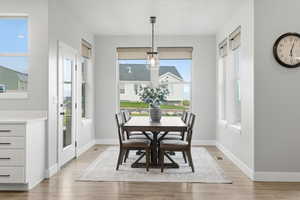 Dining space with light wood finished floors and baseboards