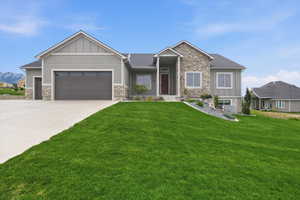 Craftsman-style home with stone siding, board and batten siding, and an attached garage