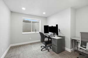 Office area featuring light colored carpet and recessed lighting