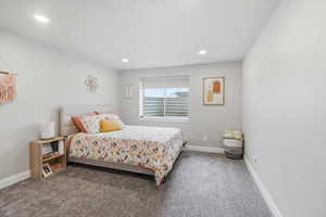 Bedroom with dark carpet and recessed lighting