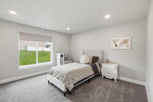 Carpeted bedroom featuring baseboards and recessed lighting