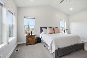 Carpeted bedroom featuring vaulted ceiling, a ceiling fan, and recessed lighting