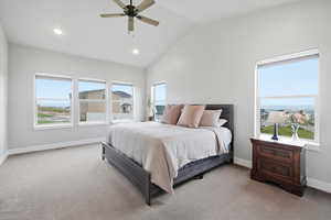 Bedroom featuring lofted ceiling, light colored carpet, recessed lighting, ceiling fan, and multiple windows