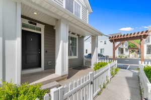View of exterior entry featuring covered porch