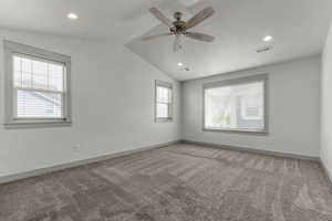 Carpeted empty room with a ceiling fan, lofted ceiling, healthy amount of natural light, and recessed lighting