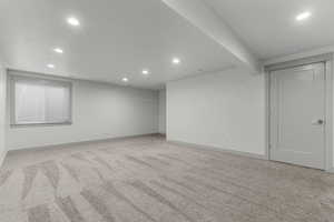 Finished basement featuring recessed lighting and light colored carpet