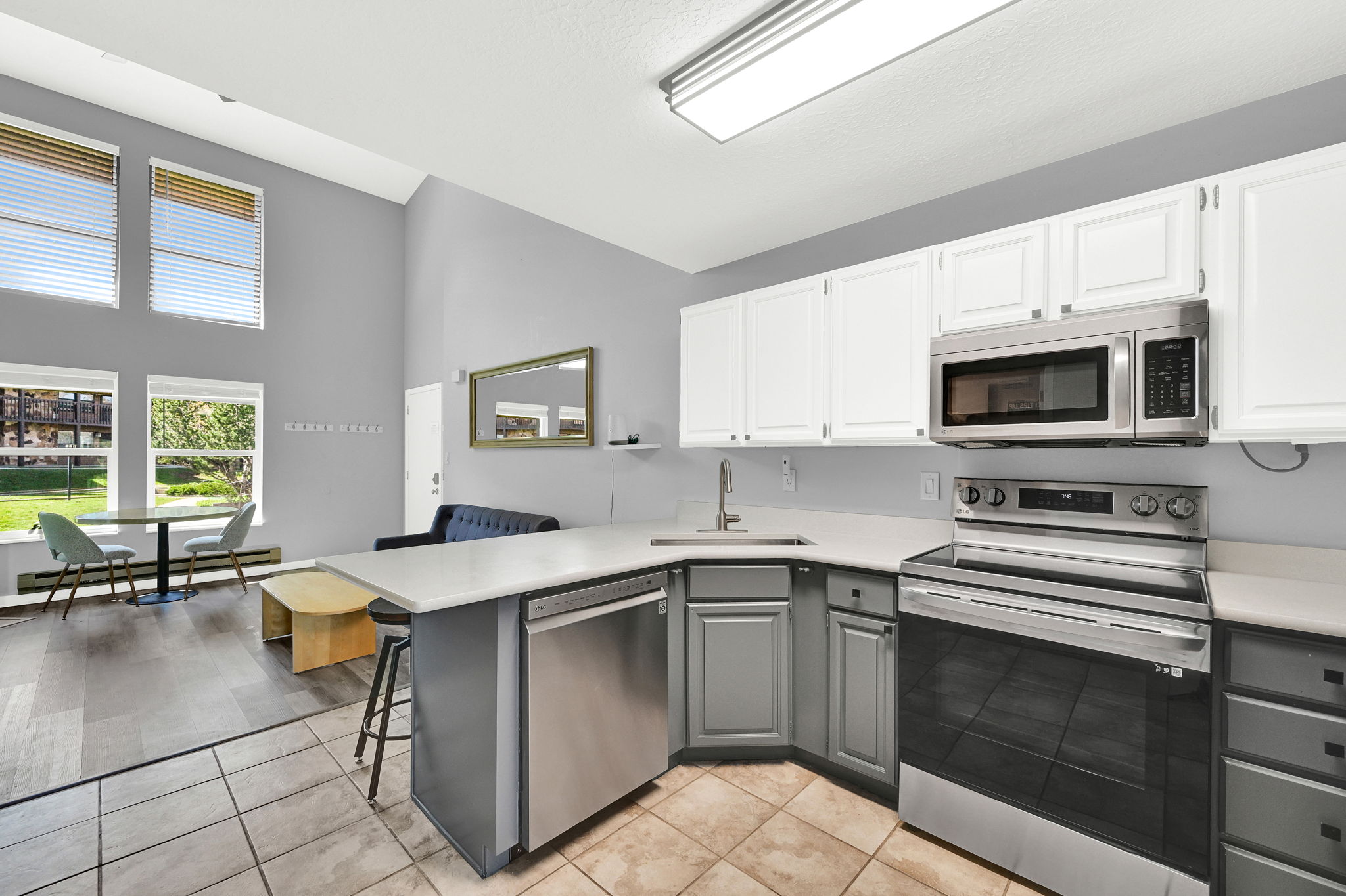 Updated Kitchen with two-tone paint and quarts countertops with stainless steel appliance package.
