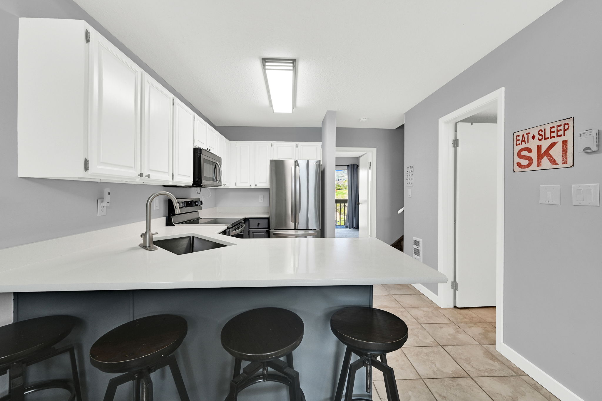 Updated Kitchen with two-tone paint and quarts countertops with stainless steel appliance package.