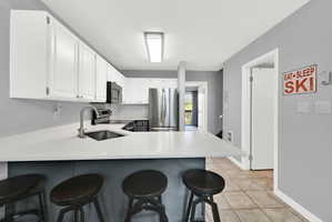Updated Kitchen with two-tone paint and quarts countertops with stainless steel appliance package.