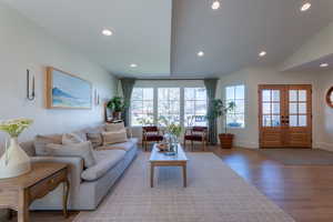 Living area with wood finished floors, french doors, and recessed lighting