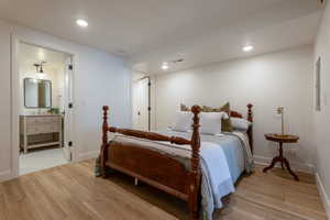 Bedroom featuring light wood-style flooring, recessed lighting, and ensuite bathroom