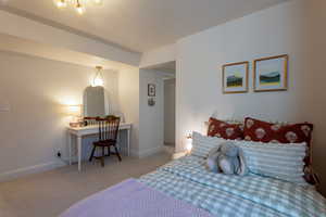 Bedroom with light carpet and baseboards