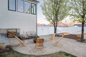 Fenced backyard with a mountain view, a patio area, and a gate
