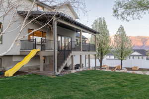 Back of house with a mountain view and stucco siding