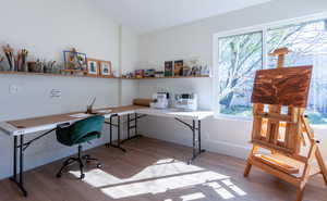 Office featuring light wood-style flooring, built in study area, and lofted ceiling