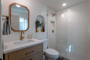 Full bathroom with vanity and tiled shower