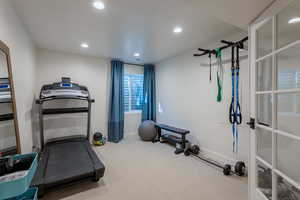Workout room with light carpet and recessed lighting