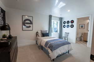 Bedroom with light carpet, ensuite bathroom, and recessed lighting