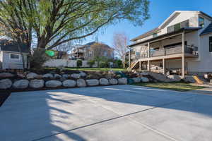 View of sport court with a patio, a deck, and a residential view