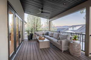 Wooden deck featuring outdoor lounge area, a mountain view, and a ceiling fan