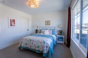 Carpeted bedroom with baseboards
