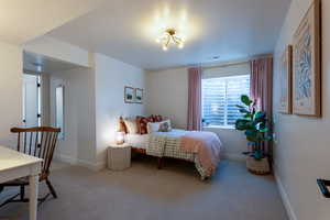 Bedroom featuring light colored carpet and baseboards
