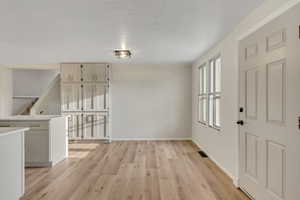 Entryway featuring light wood finished floors and baseboards
