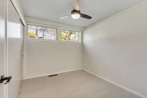Unfurnished room with light carpet and ceiling fan