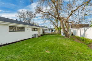 Fenced yard featuring an outbuilding