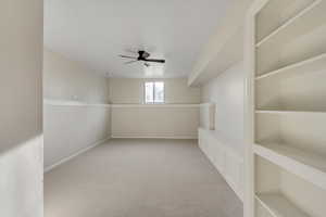 Spare room with light carpet and a ceiling fan