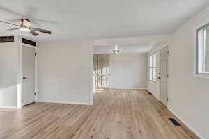 Empty room with light wood-type flooring and ceiling fan
